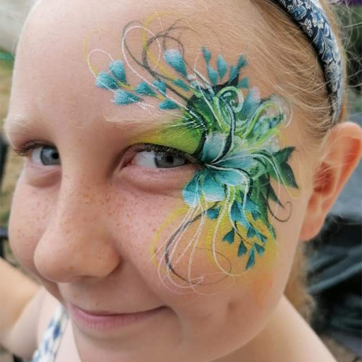 Incredible foliate face painting design in blue's, yellow and green