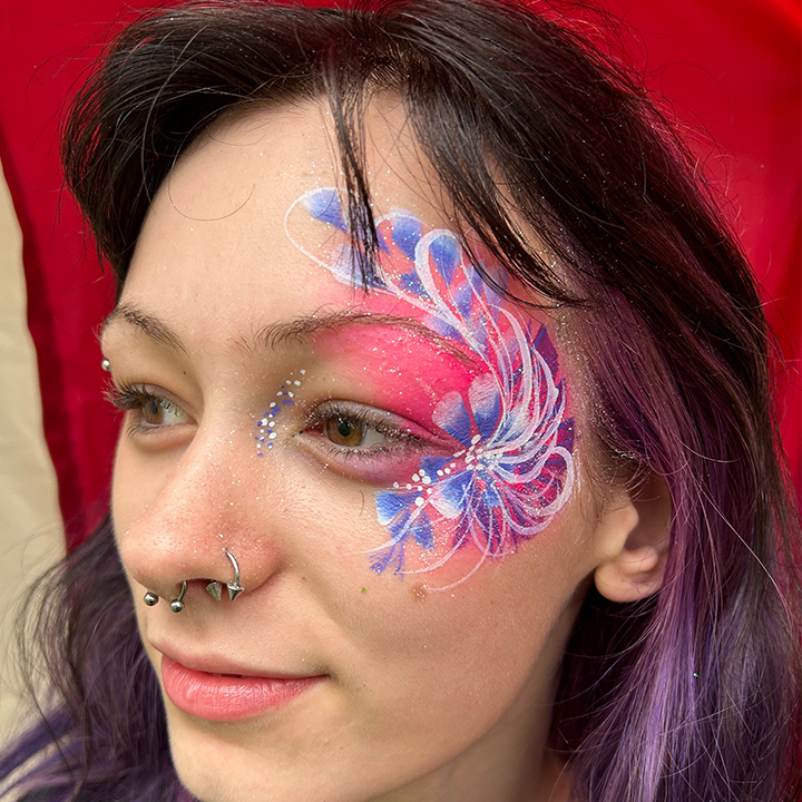 Image of festival goer with floral face painting design